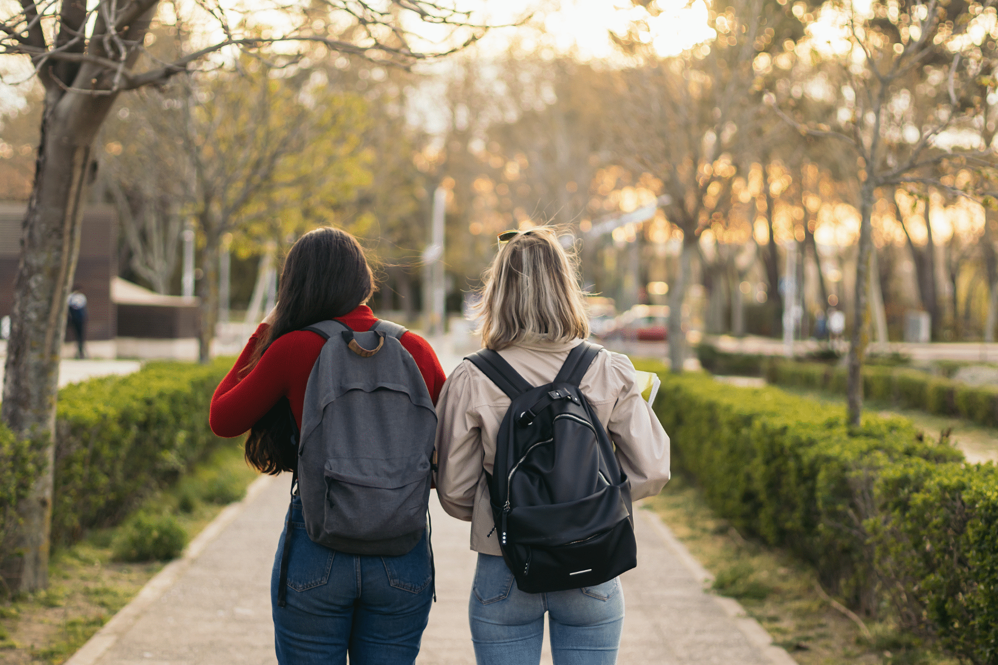 Students walking with backpacks in the Fall season